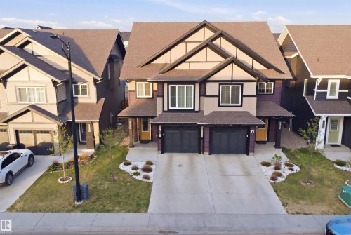 Duplex exterior with multiple gables and a combination of siding and trim - 2284 Chokecherry Close, Edmonton, AB - Outdoor With Facade