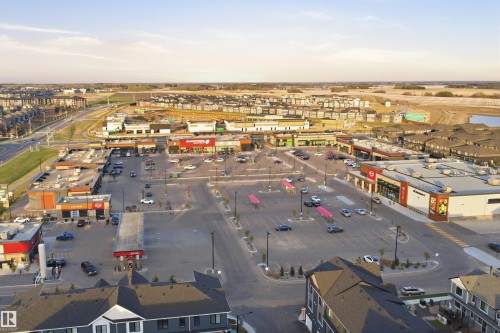 Commercial development featuring multiple storefronts, ample surface parking, and a gas station - 2284 Chokecherry Close, Edmonton, AB - Outdoor With View