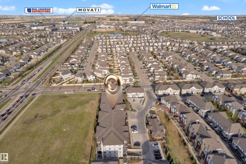 Aerial view showcasing a residential neighborhood with numerous homes featuring dark roofs - 217 667 Watt Boulevard, Edmonton, AB - Outdoor With View