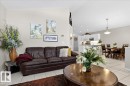 The open-concept living area features light-colored walls and tiled flooring - 3518 18 Street, Edmonton, AB  - Indoor Photo Showing Living Room 