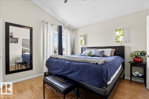 This bedroom features light wood flooring and a vaulted ceiling - 3518 18 Street, Edmonton, AB - Indoor Photo Showing Bedroom
