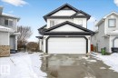 The property features a two-story exterior with white siding and dark trim, accented by a white garage door - 3518 18 Street, Edmonton, AB  - Outdoor 