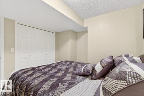 Bedroom featuring light-colored walls and a closet with bi-fold doors - 3518 18 Street, Edmonton, AB - Indoor Photo Showing Bedroom
