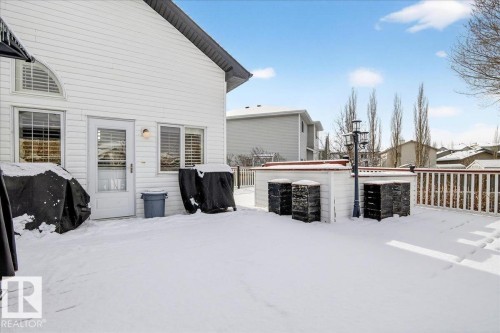 The property features a spacious deck with a white railing, providing an inviting outdoor space - 3518 18 Street, Edmonton, AB - Outdoor