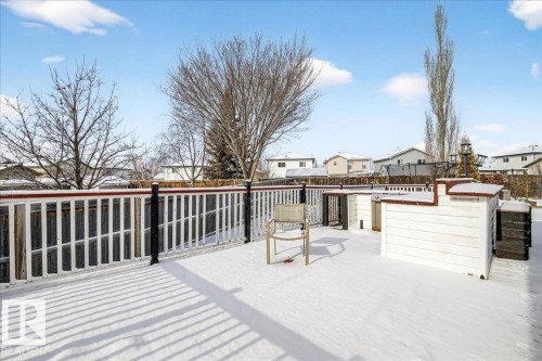 The property features an outdoor deck with white fencing and a dark top rail, offering an expansive space - 3518 18 Street, Edmonton, AB - Outdoor