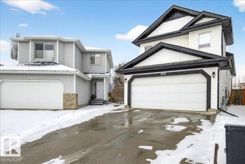 The property features a two-story exterior with siding, an attached garage, and a paved driveway - 3518 18 Street, Edmonton, AB - Outdoor