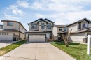 Two-story residence featuring light-toned siding with contrasting dark trim accents and a prominent two-car garage - 2138 32B Street, Edmonton, AB  - Outdoor With Facade 