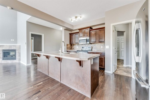 Kitchen island with an undermount sink and a gooseneck faucet - 2138 32B Street, Edmonton, AB - Indoor Photo Showing Kitchen