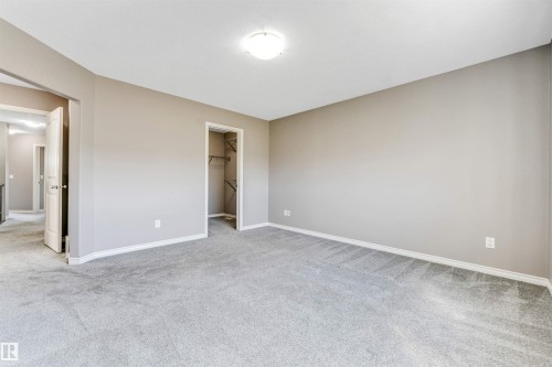 Spacious room featuring light gray carpeting, neutral-toned walls, white trim, and a ceiling-mounted light fixture - 2138 32B Street, Edmonton, AB - Indoor Photo Showing Other Room