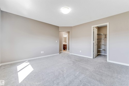 Spacious room featuring neutral-toned walls, light gray carpeting, and white trim - 2138 32B Street, Edmonton, AB - Indoor Photo Showing Other Room