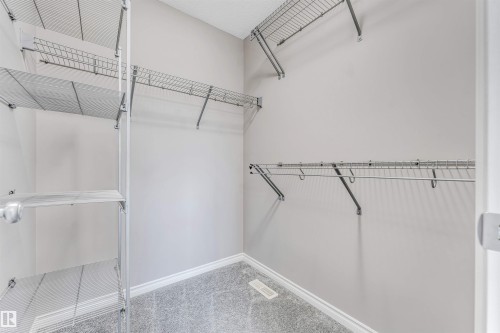 Closet featuring light gray walls, wall-to-wall carpeting, and multiple wire shelving units - 2138 32B Street, Edmonton, AB - Indoor With Storage