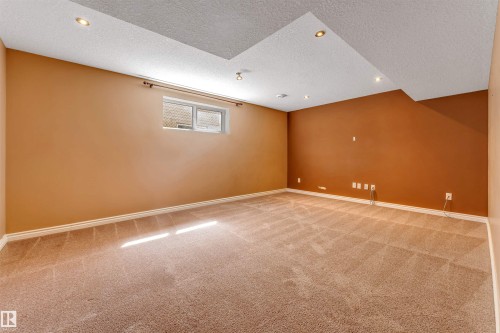 Carpeted room featuring a drop ceiling with recessed lighting - 2138 32B Street, Edmonton, AB - Indoor Photo Showing Other Room