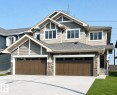Craftsman-style facade featuring multiple gables, horizontal siding, shake siding, stone accents, and a two-car garage with panel doors - 19632 29 Avenue, Edmonton, AB  - Outdoor With Facade 