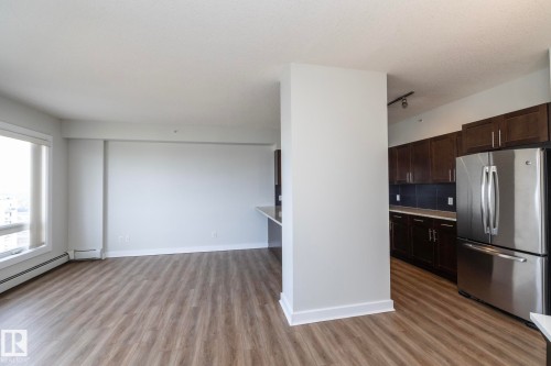 Spacious living area featuring wood-finish flooring, large windows, and a neutral color palette - 3104 10152 104 Street, Edmonton, AB - Indoor Photo Showing Kitchen