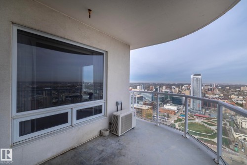 Curved balcony with glass railing, providing an elevated city panorama - 3104 10152 104 Street, Edmonton, AB - Outdoor With View With Exterior