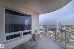 Curved balcony with glass railing, providing an elevated city panorama - 