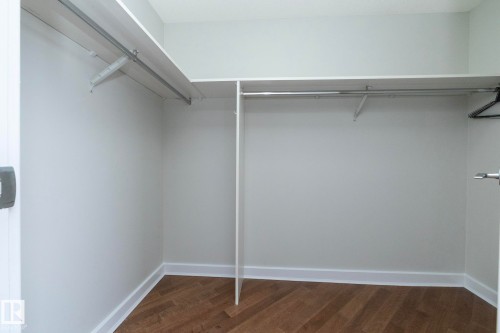 Customizable closet system featuring upper shelving and multiple hanging rods - 3104 10152 104 Street, Edmonton, AB - Indoor With Storage