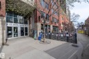 Commercial storefront with large glass entry doors and transom windows, brick facade, and stone-clad accents - 3104 10152 104 Street, Edmonton, AB  - Outdoor 