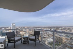 Expansive balcony with clear glass railings and city panorama - 
