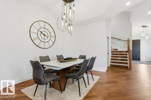 Hardwood flooring in a herringbone pattern extending through the space - 1 Sparrow Close, Fort Saskatchewan, AB - Indoor Photo Showing Dining Room