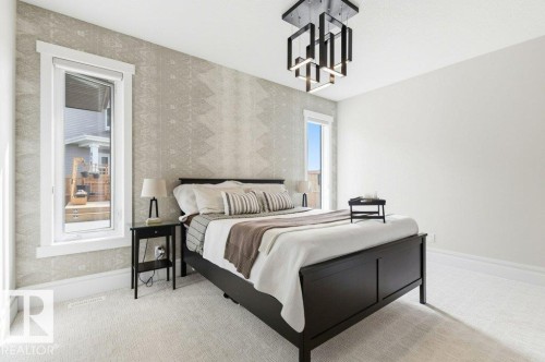 Light-toned wall-to-wall carpeting complements the white baseboards and window trim - 1 Sparrow Close, Fort Saskatchewan, AB - Indoor Photo Showing Bedroom