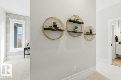 Hallway featuring a trio of round, gold-tone metal wall shelves - 1 Sparrow Close, Fort Saskatchewan, AB - Indoor Photo Showing Bathroom