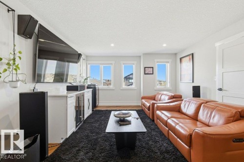 Living area featuring hardwood-finish flooring, recessed lighting, and bright white trim - 1 Sparrow Close, Fort Saskatchewan, AB - Indoor Photo Showing Living Room