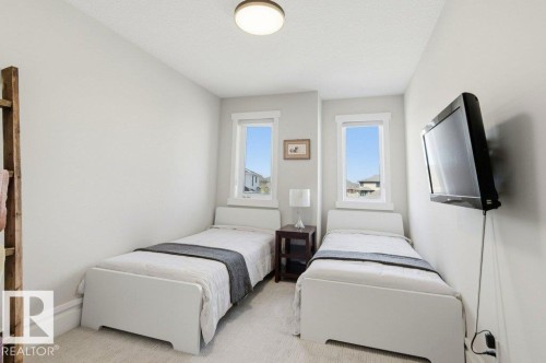 Bright room featuring two windows with white trim, light-toned walls, and a ceiling-mounted light fixture - 1 Sparrow Close, Fort Saskatchewan, AB - Indoor