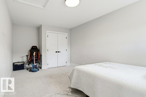 Room featuring light-colored carpeting, white baseboards, and neutral wall paint - 1 Sparrow Close, Fort Saskatchewan, AB - Indoor Photo Showing Bedroom