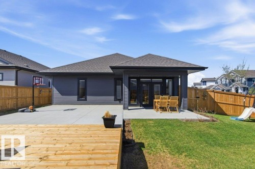 Rear exterior featuring dark gray siding and a gray shingled roof - 1 Sparrow Close, Fort Saskatchewan, AB - Outdoor With Deck Patio Veranda