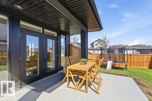 Rear exterior featuring a concrete patio, covered outdoor area, and private fenced yard - 1 Sparrow Close, Fort Saskatchewan, AB - Outdoor With Deck Patio Veranda