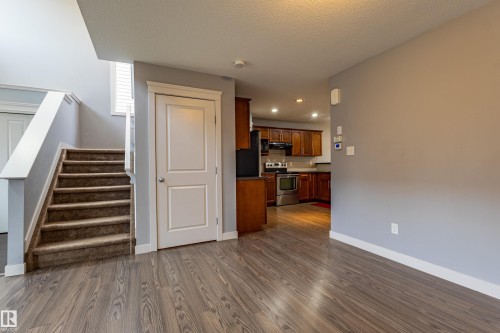 Wood-finish flooring throughout the main level - 17715 6 Avenue, Edmonton, AB - Indoor