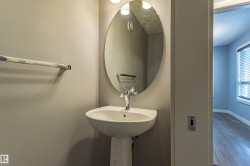 Pedestal sink with chrome faucet and oval mirror - 