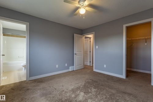Carpeted room with neutral gray walls, a ceiling fan, and white trim - 17715 6 Avenue, Edmonton, AB - Indoor Photo Showing Other Room