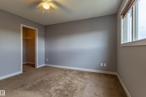 Carpeted room with light gray walls and white baseboards - 17715 6 Avenue, Edmonton, AB - Indoor Photo Showing Other Room