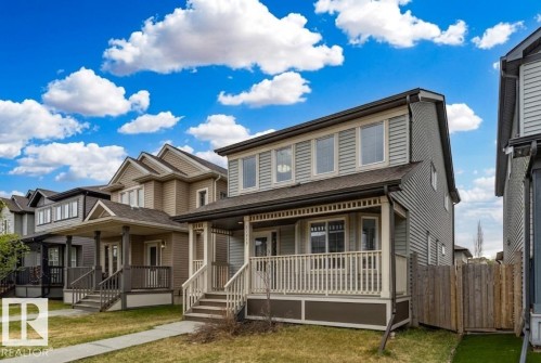 Two-story residential property featuring light gray siding and a dark roof - 17715 6 Avenue, Edmonton, AB - Outdoor With Deck Patio Veranda With Facade
