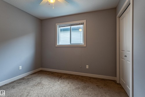 Carpeted room with neutral gray walls and white trim - 17715 6 Avenue, Edmonton, AB - Indoor Photo Showing Other Room