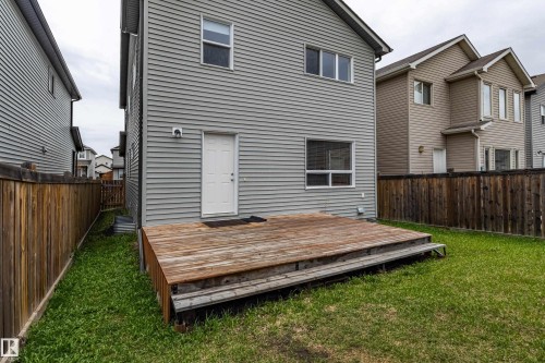 Private backyard featuring a wood deck and a level lawn area - 17715 6 Avenue, Edmonton, AB - Outdoor With Exterior