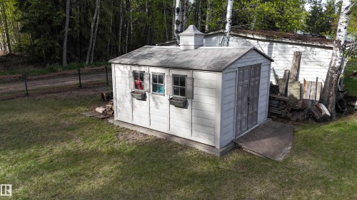 Detached shed featuring a cupola, dual front doors, two windows with shutters, and flower boxes - 7126 4A Ave, Edson, AB - Outdoor