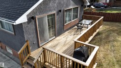 Expansive wood deck with full railings and stairs - 