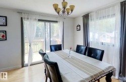 Dining area featuring light wood-finish flooring and a multi-light chandelier - 