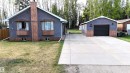 Grey stucco exterior featuring two bay windows with wood-finish accents - 7126 4A Ave, Edson, AB  - Outdoor 