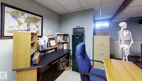 Light blue painted walls with a drop ceiling featuring fluorescent lighting - 7126 4A Ave, Edson, AB - Indoor