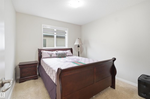 Bedroom featuring light-toned walls and plush carpet flooring - 1444 37C Avenue, Edmonton, AB - Indoor Photo Showing Bedroom