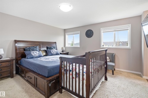 Bright bedroom with neutral wall paint and light-toned carpet flooring - 1444 37C Avenue, Edmonton, AB - Indoor Photo Showing Bedroom