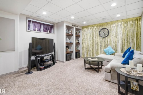 Finished lower level featuring recessed lighting, plush carpet flooring, built-in shelving, and a drop ceiling - 1444 37C Avenue, Edmonton, AB - Indoor