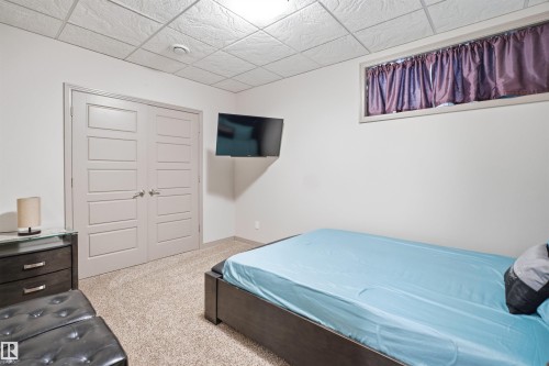 Neutral wall color with textured ceiling panels and recessed lighting - 1444 37C Avenue, Edmonton, AB - Indoor Photo Showing Bedroom