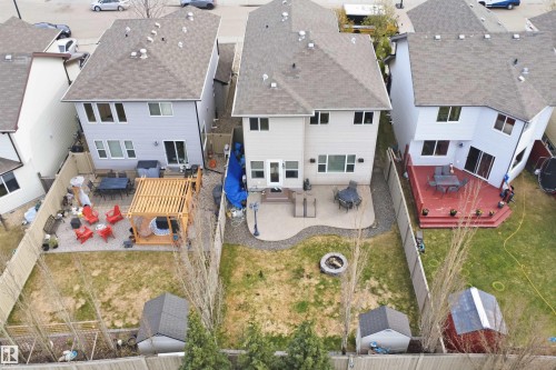 Rear exterior featuring light grey siding and a shingle roof - 1444 37C Avenue, Edmonton, AB - Outdoor