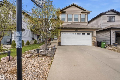 Two-story residence featuring light-colored siding and a contrasting dark roof - 1444 37C Avenue, Edmonton, AB - Outdoor