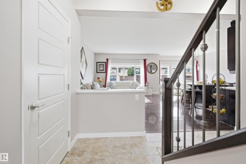 Entryway featuring light-toned tile flooring and a multi-panel interior door - 1444 37C Avenue, Edmonton, AB - Indoor Photo Showing Other Room